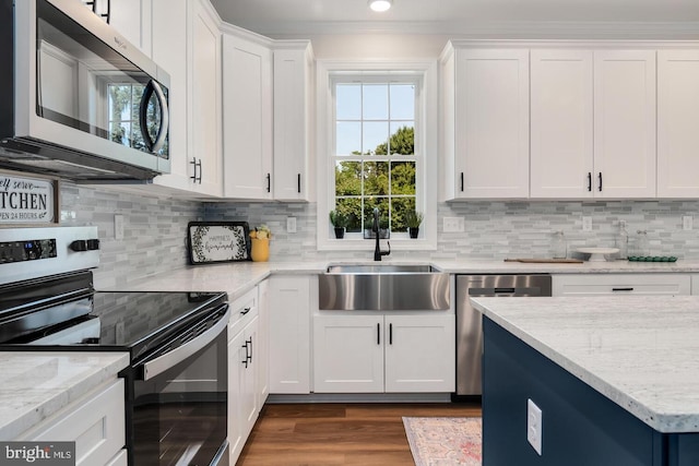 kitchen featuring light stone counters, sink, white cabinets, and appliances with stainless steel finishes