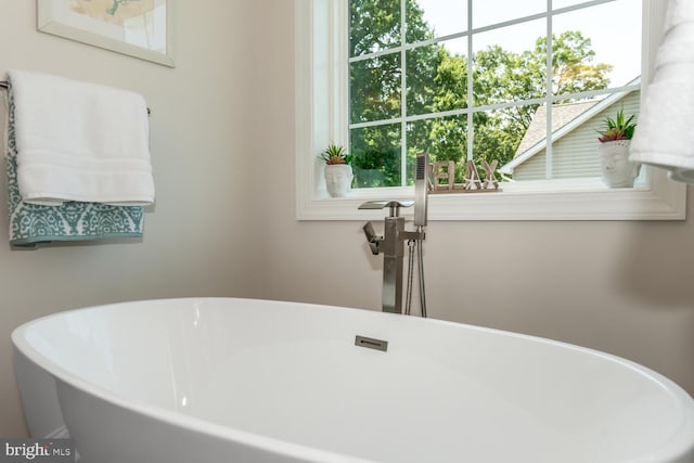 bathroom featuring sink and a bath