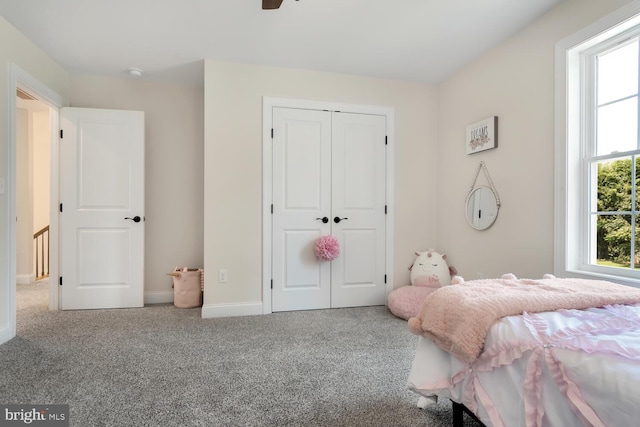 carpeted bedroom with a closet and ceiling fan