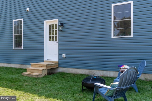 doorway to property featuring a yard