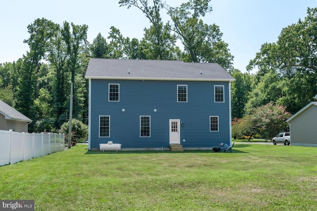 rear view of property with a yard