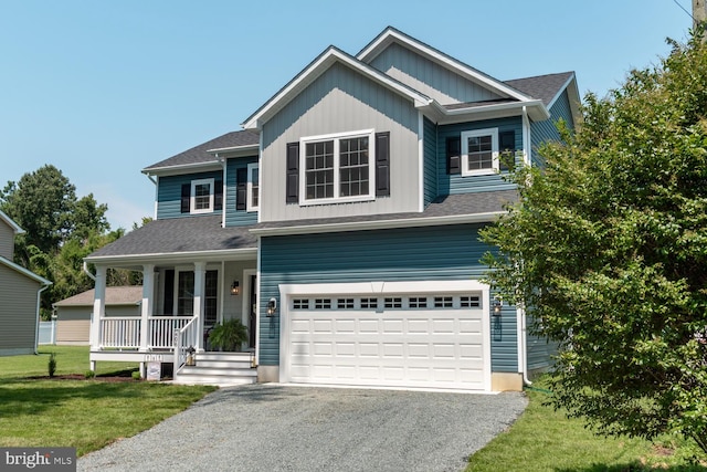 craftsman-style house with a garage, covered porch, and a front lawn