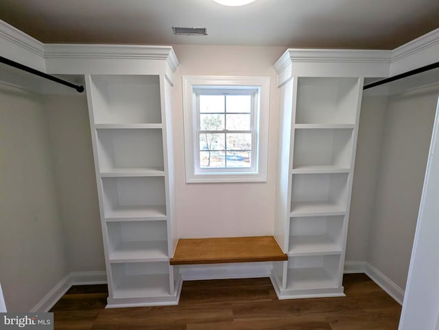 spacious closet with dark hardwood / wood-style floors