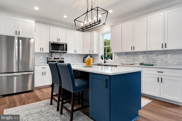 kitchen with white cabinetry, appliances with stainless steel finishes, and a center island