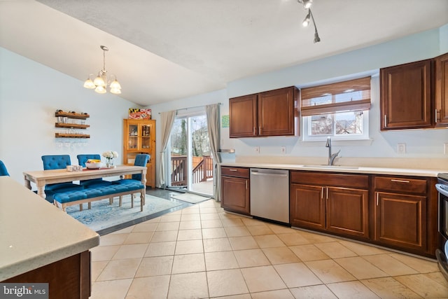 kitchen featuring a notable chandelier, sink, vaulted ceiling, stainless steel dishwasher, and decorative light fixtures