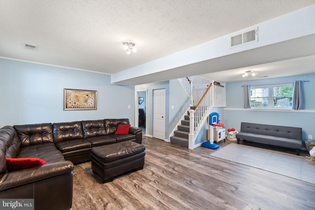 living room with hardwood / wood-style floors and a textured ceiling