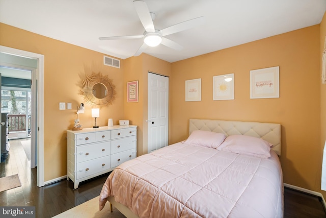 bedroom with a closet, dark hardwood / wood-style floors, and ceiling fan