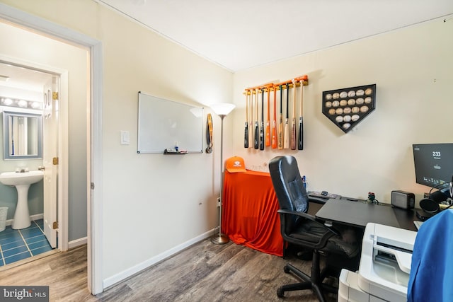 office area with wood-type flooring and sink