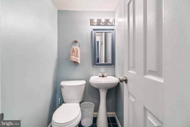 bathroom featuring sink, tile patterned flooring, and toilet