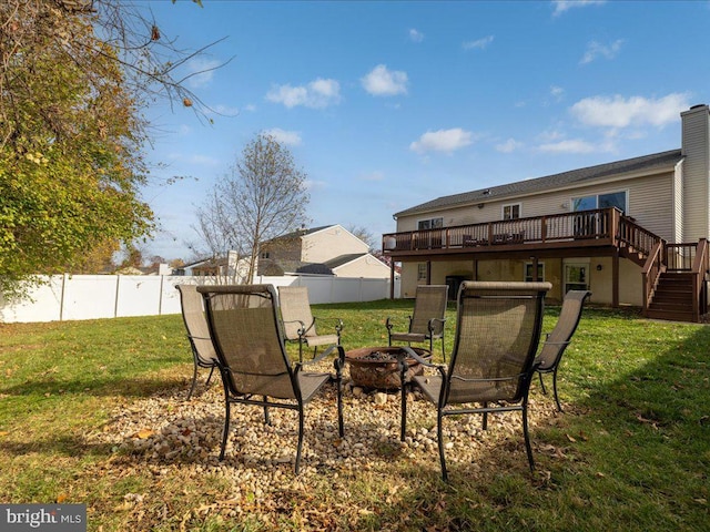 view of yard featuring a fire pit and a deck