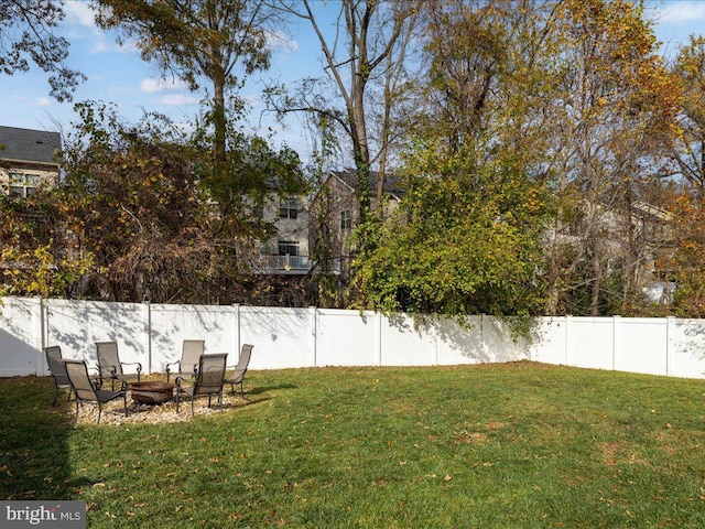 view of yard with a fire pit