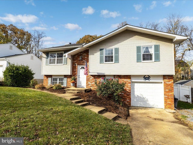 bi-level home with a front lawn and a garage