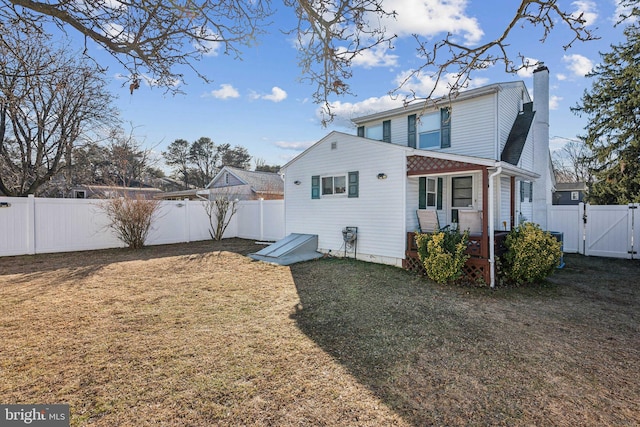 back of house with a yard