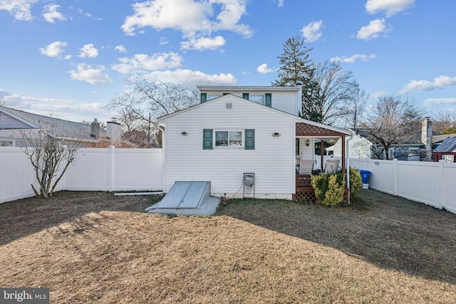 back of property with a porch and a yard