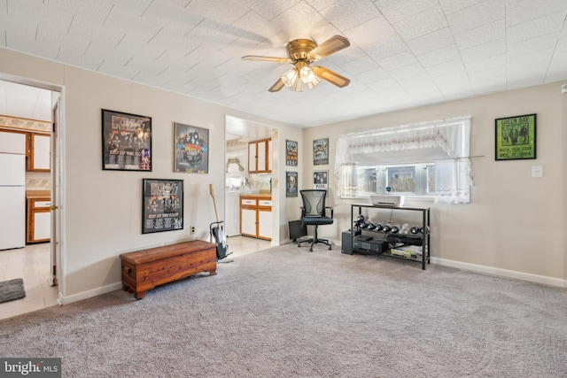 sitting room featuring ceiling fan and light carpet