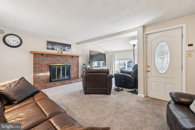 living room with beamed ceiling, carpet floors, and a fireplace