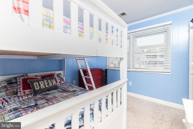 bedroom with crown molding and carpet