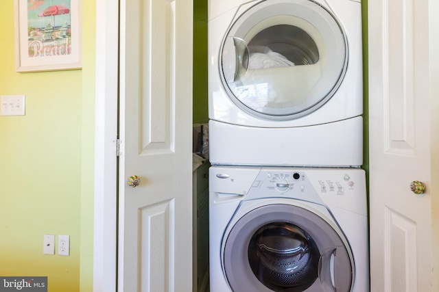 laundry area featuring stacked washer / dryer