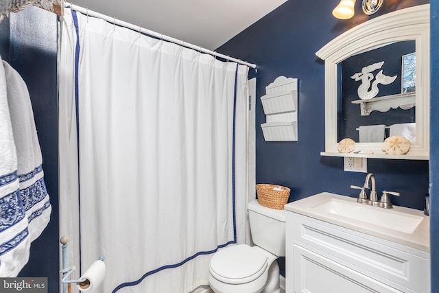 bathroom with toilet and vanity