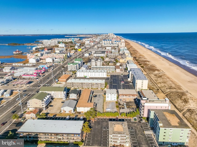 aerial view with a water view and a view of the beach