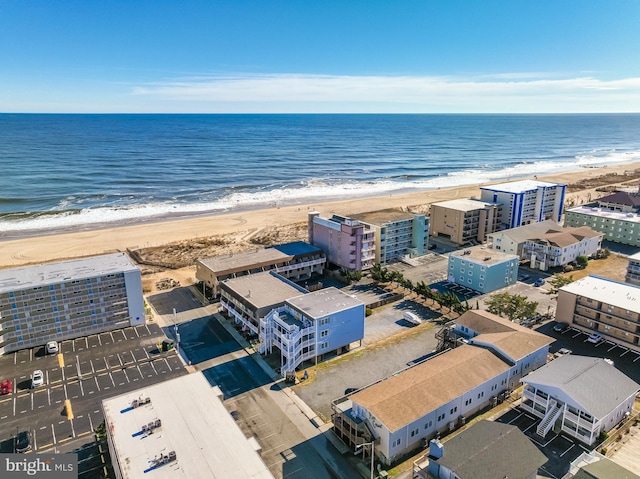 bird's eye view with a water view and a beach view