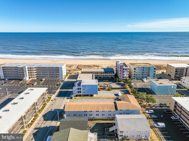 birds eye view of property featuring a water view and a beach view