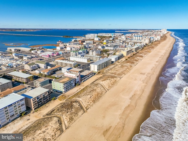 drone / aerial view with a beach view and a water view