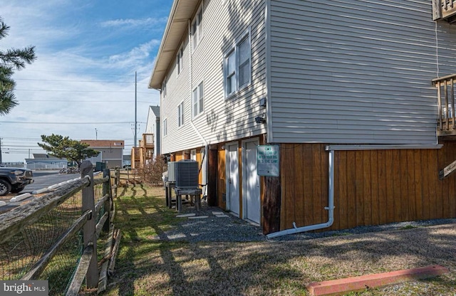 view of side of home with central AC