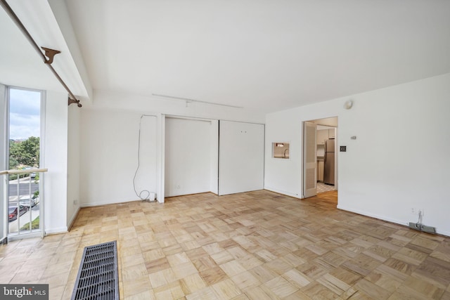 spare room with light parquet floors