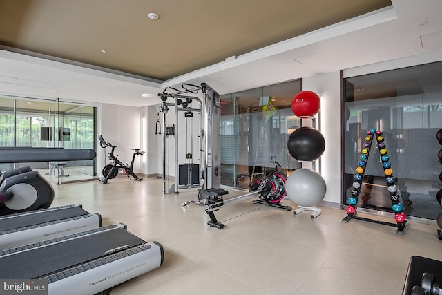 gym with a tray ceiling