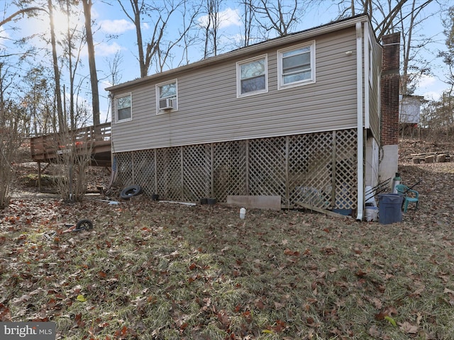 view of property exterior featuring a wooden deck