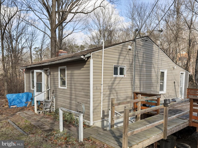 view of property exterior with a deck