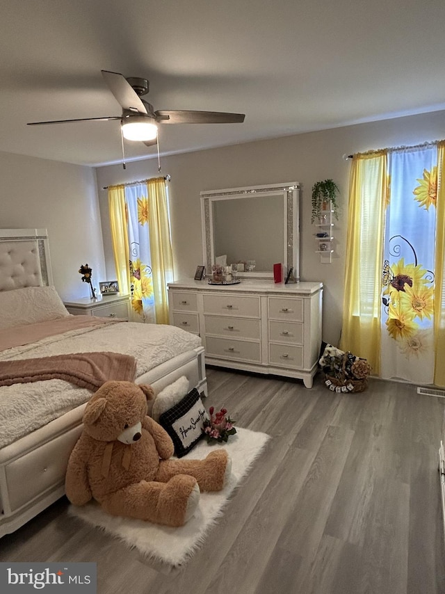 bedroom featuring hardwood / wood-style floors and ceiling fan