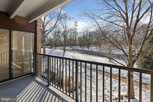 view of snow covered back of property