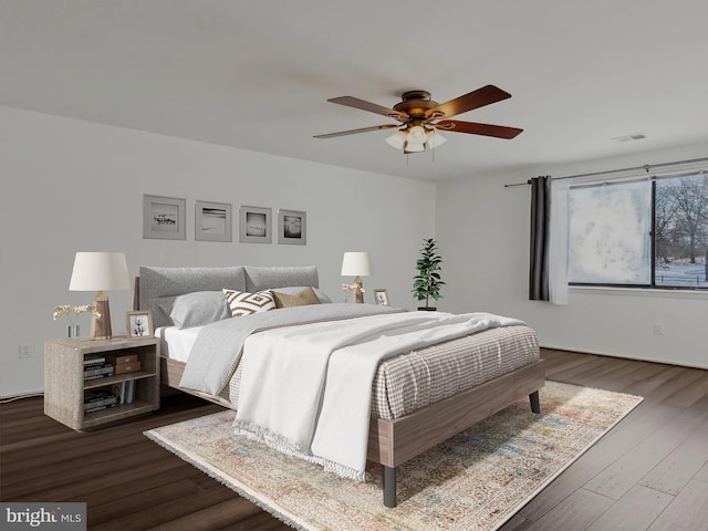 bedroom with ceiling fan and dark hardwood / wood-style floors