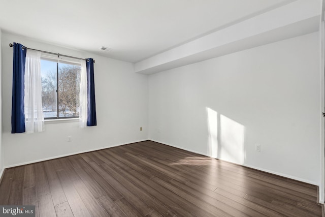 unfurnished room featuring dark hardwood / wood-style floors