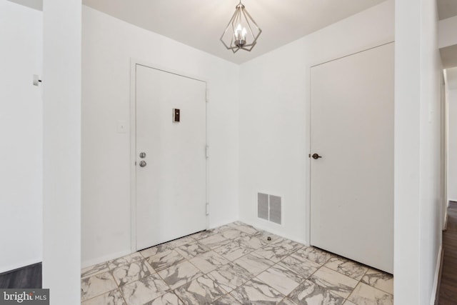 entryway featuring an inviting chandelier