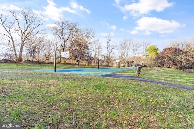 view of basketball court featuring a yard