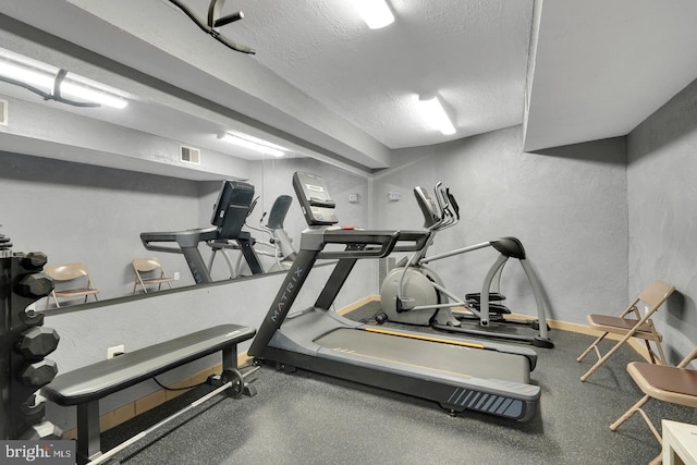 exercise area with a textured ceiling