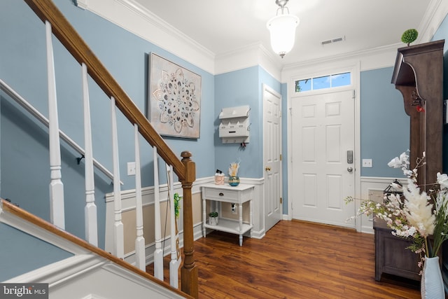 foyer featuring dark wood-type flooring and ornamental molding