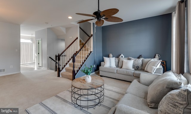 living room featuring light colored carpet and ceiling fan