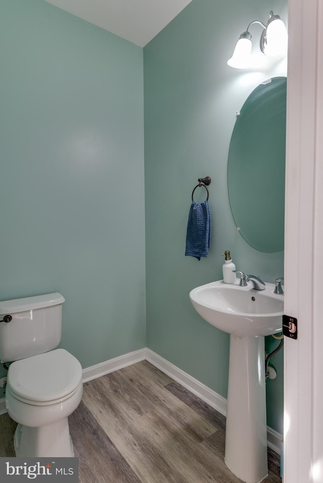 bathroom featuring sink, hardwood / wood-style flooring, and toilet