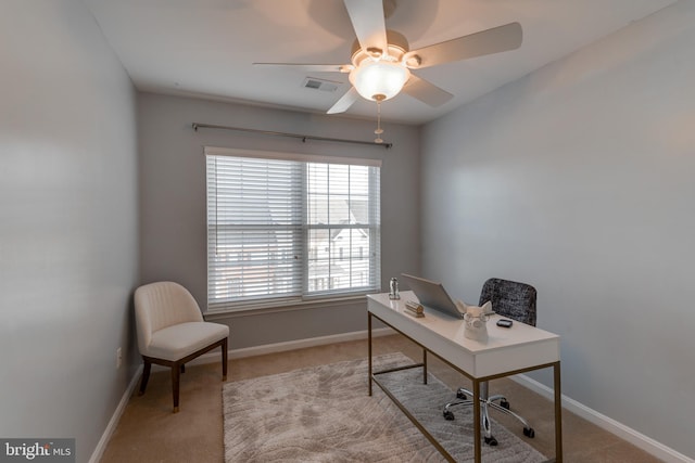 office space with light carpet and ceiling fan