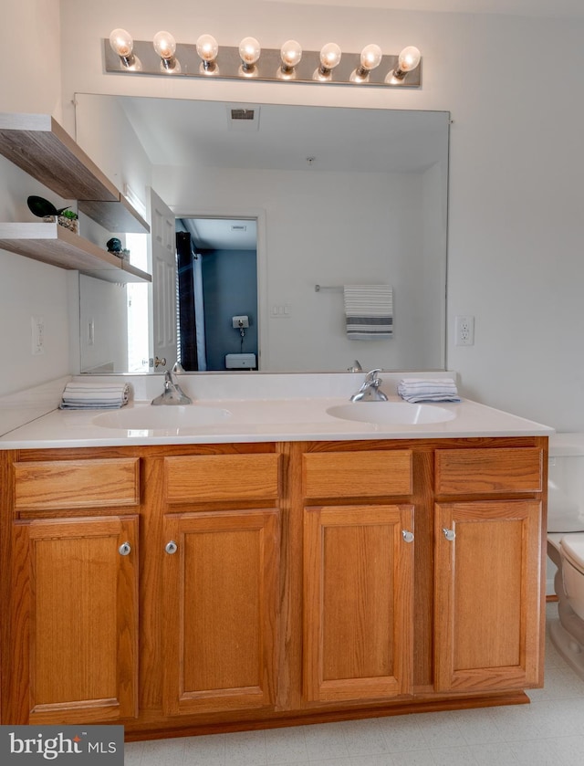 bathroom with vanity and toilet