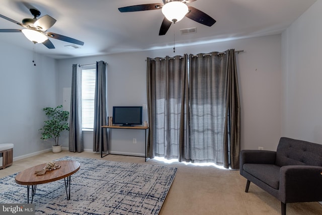 living room featuring ceiling fan and light colored carpet