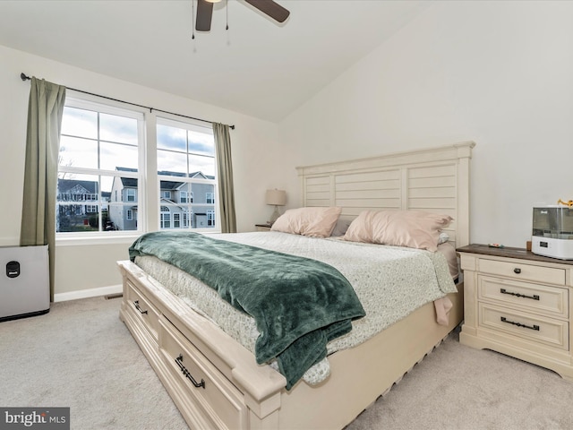 carpeted bedroom featuring vaulted ceiling and ceiling fan