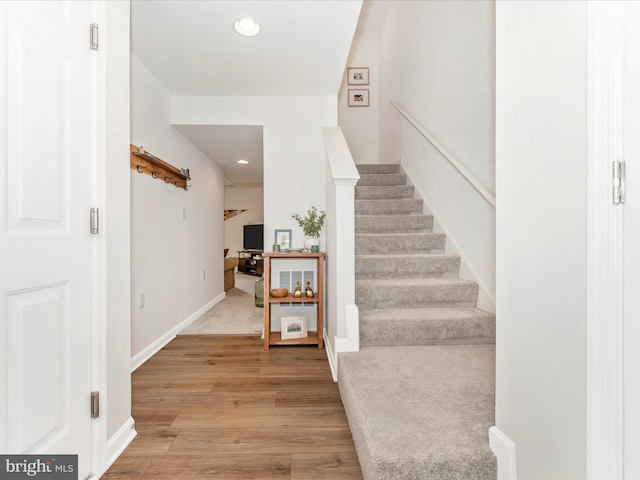 staircase with hardwood / wood-style floors