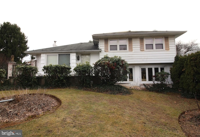 back of house featuring a yard