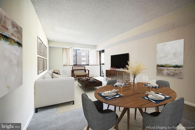 carpeted dining space featuring a textured ceiling