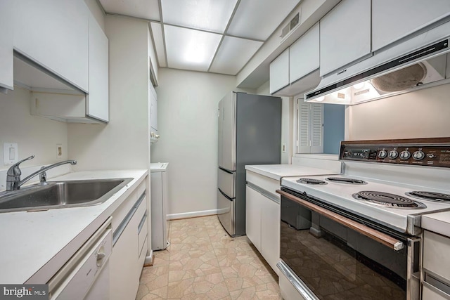 kitchen featuring electric range, sink, dishwasher, stainless steel fridge, and white cabinets